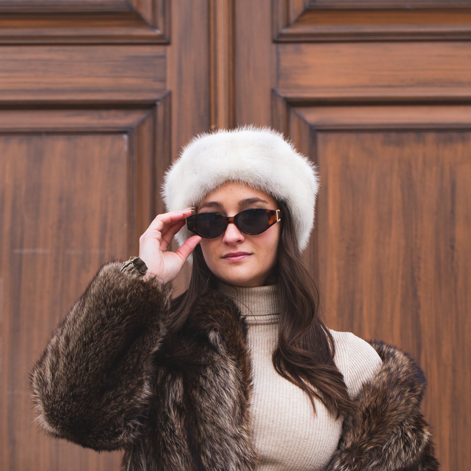Women with a white real fur hat and leather