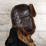brown leather and fur trapper hat
