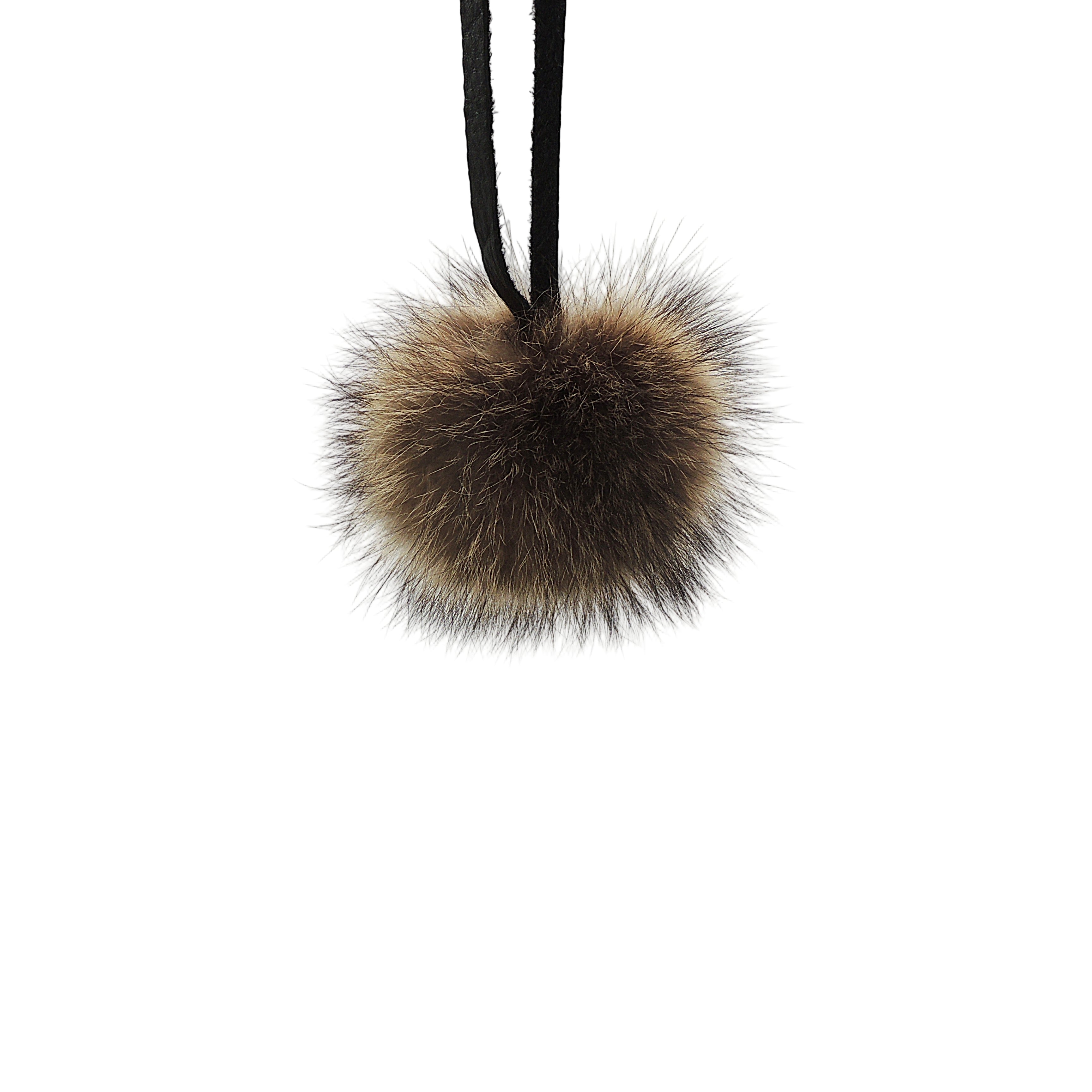 Genuine raccoon fur pom-pom with leather tie strap. Handmade in Quebec. Full, rounded volume for beanies, hoods and bags.