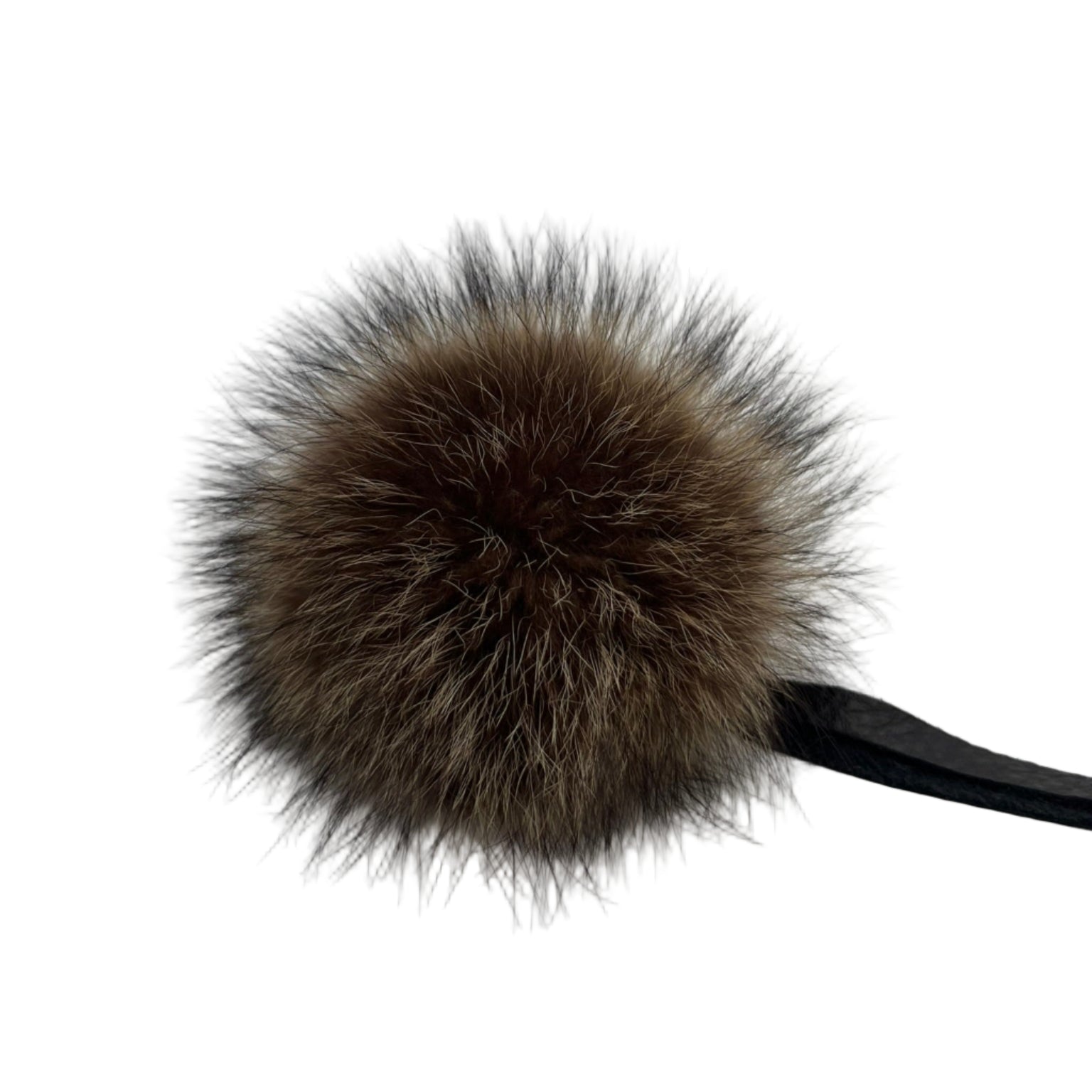 Genuine raccoon fur pom-pom with leather tie strap. Handmade in Quebec. Full, rounded volume for beanies, hoods and bags.